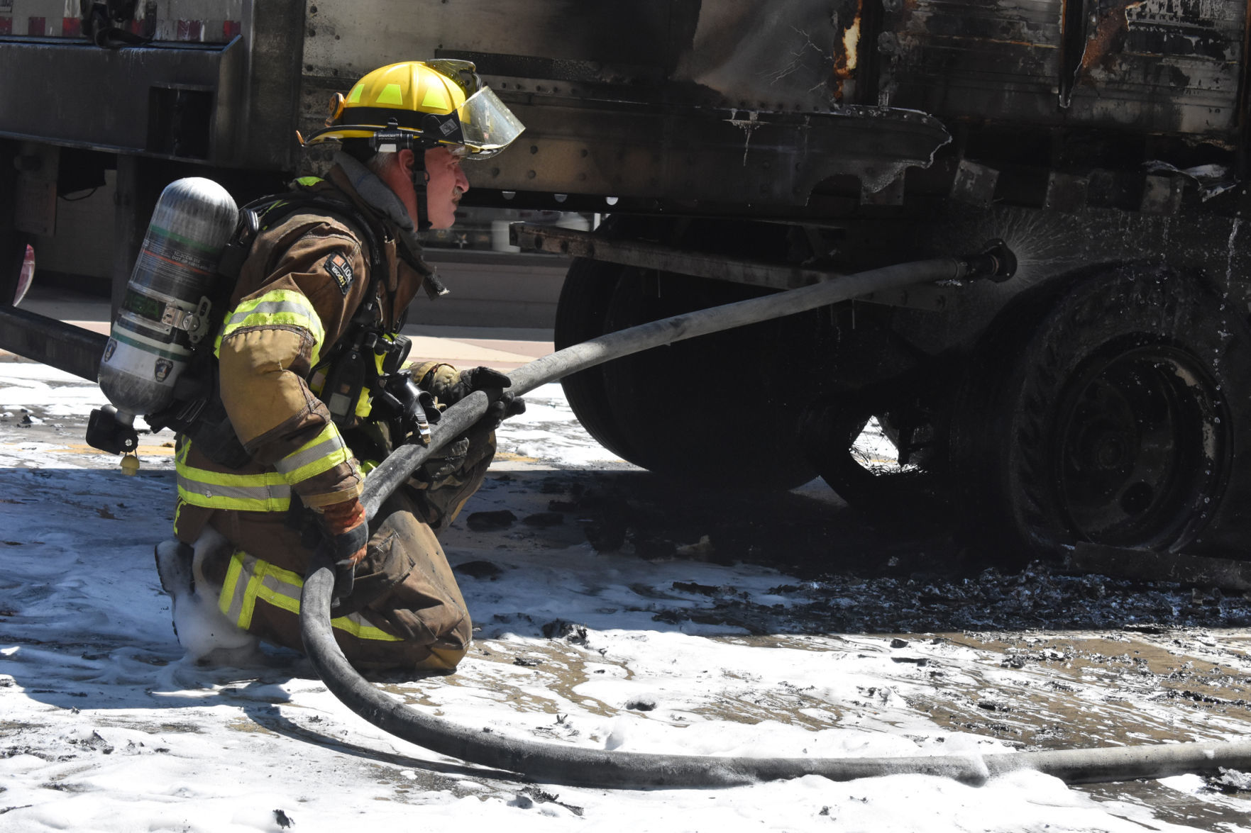 Portage firefighter sprays damaged semitrailer